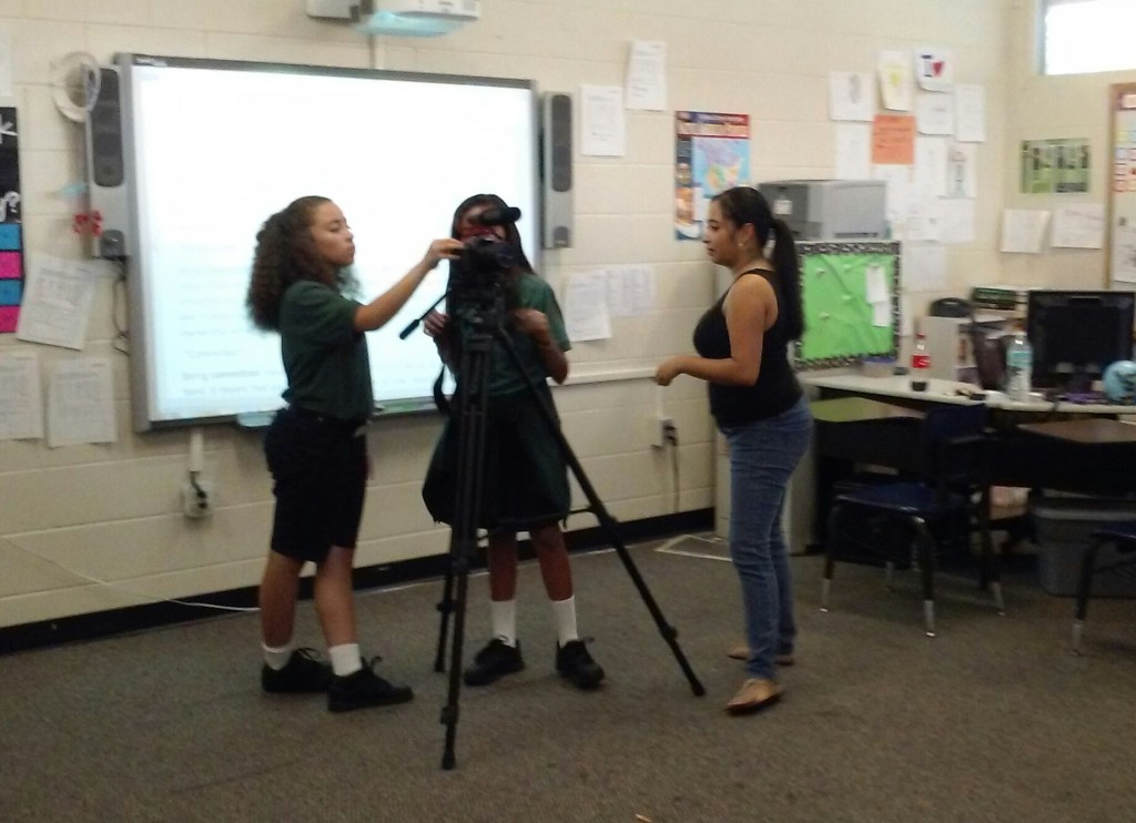 Students in the PBS Newshour Student Reporting Labs program set up a camera with help from NNB reporters. 